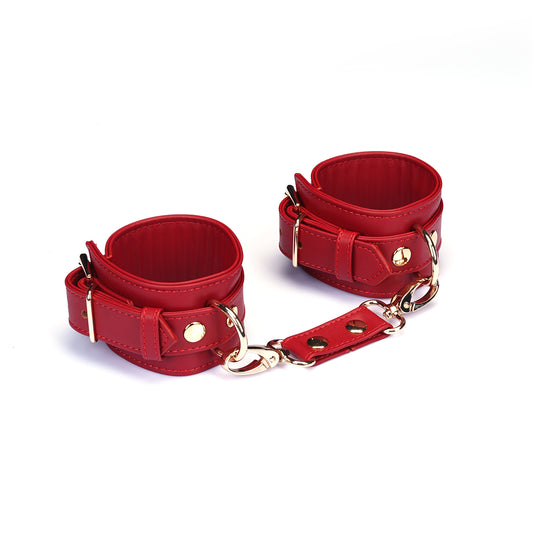 Red faux leather and gold metal handcuffs